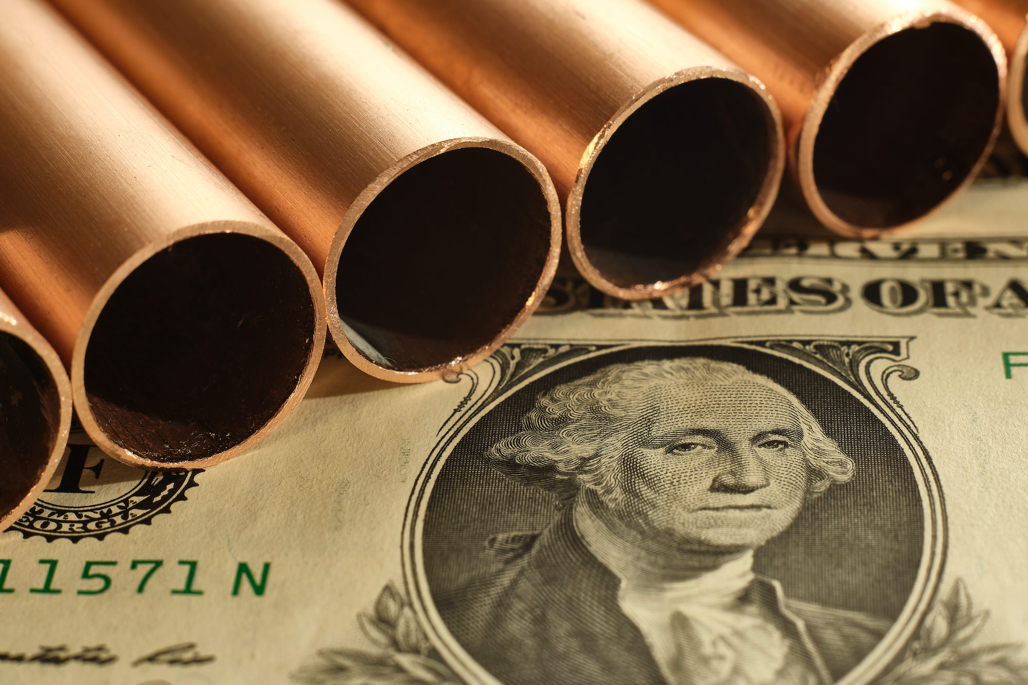Close,Up,Of,Copper,Pipes,And,United,States,Dollar.,Commodity Copper’s Volatile 2025: Price Swings, Tariffs, and Russia’s Arctic Ambitions Reshape the Market
